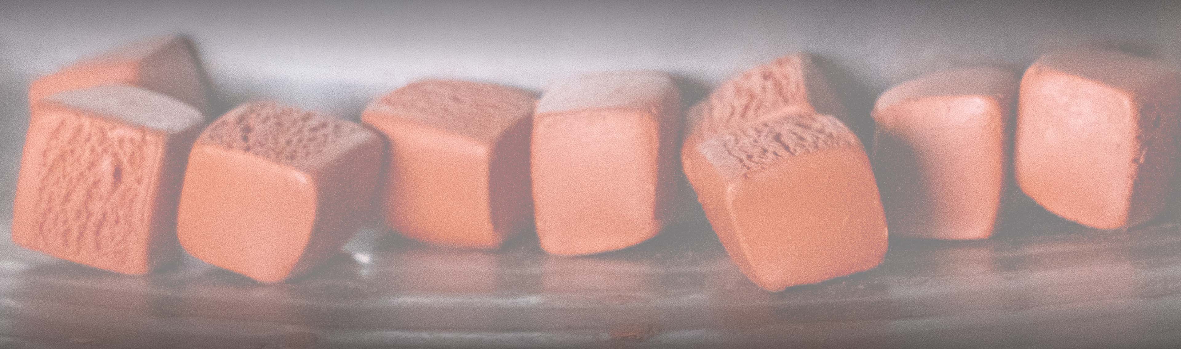 Chucnks of orange silicone being manufactured.